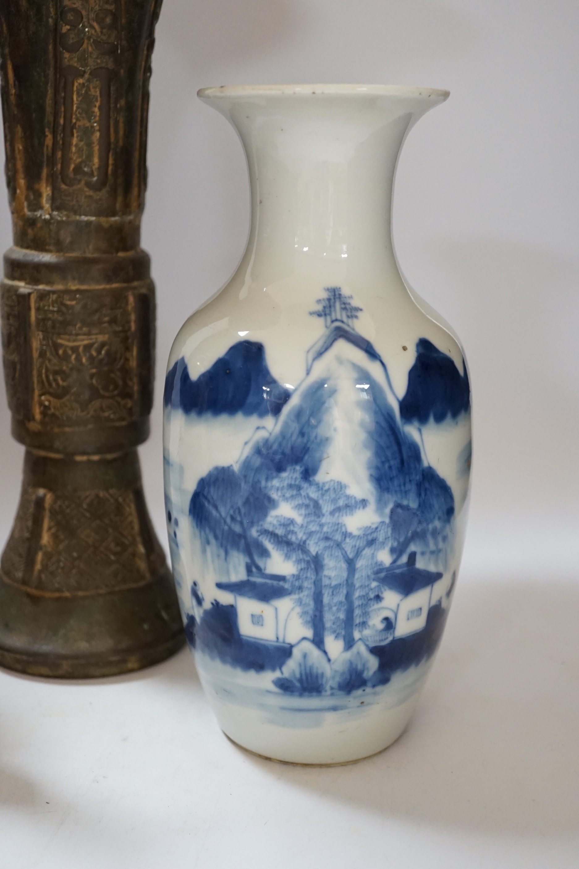 A Chinese bronze gu vase, a 19th century Chinese blue and white vase and a Tibetan teapot, tallest 34cm